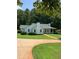 White house with green roof and walkway, surrounded by trees at 3639 Holly Springs Rd, Rockmart, GA 30153