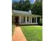 Front porch with red door and brick steps leading to the yard at 3639 Holly Springs Rd, Rockmart, GA 30153