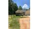 Small white guest house with screened porch and parking area at 3639 Holly Springs Rd, Rockmart, GA 30153