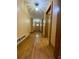 Long hallway with hardwood floors and access to multiple rooms at 3639 Holly Springs Rd, Rockmart, GA 30153