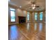 Large living room with hardwood floors, fireplace, and lots of windows at 3639 Holly Springs Rd, Rockmart, GA 30153