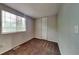 Bright bedroom featuring a large window and brown carpet at 620 Sheringham Ct, Roswell, GA 30076