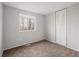 Well-lit bedroom featuring neutral walls and carpet at 620 Sheringham Ct, Roswell, GA 30076