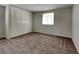 Bright bedroom with carpet and window, featuring a large closet at 620 Sheringham Ct, Roswell, GA 30076