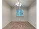 Simple dining room with neutral walls and carpeting at 620 Sheringham Ct, Roswell, GA 30076