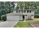 Two-story house with gray siding, two-car garage, and landscaping at 620 Sheringham Ct, Roswell, GA 30076