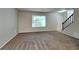 Spacious living room with neutral carpeting and large window at 620 Sheringham Ct, Roswell, GA 30076