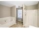 Main bathroom with soaking tub and separate shower at 646 Lakes Cir, Lithonia, GA 30058