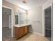 Double vanity bathroom with wood cabinets and tile floors at 646 Lakes Cir, Lithonia, GA 30058