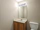 Simple bathroom with wood vanity and rectangular mirror at 646 Lakes Cir, Lithonia, GA 30058