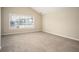 Spacious carpeted bedroom with large window and neutral walls at 646 Lakes Cir, Lithonia, GA 30058