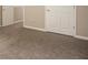 Carpeted bedroom with neutral walls and double doors at 646 Lakes Cir, Lithonia, GA 30058