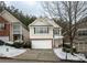 Two-story townhome with a white garage door and snow-covered landscaping at 646 Lakes Cir, Lithonia, GA 30058