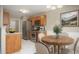 Eat-in kitchen area with stainless steel appliances, wood cabinets, and a wooden dining table at 646 Lakes Cir, Lithonia, GA 30058