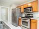 Kitchen boasts stainless steel appliances and wood cabinets at 646 Lakes Cir, Lithonia, GA 30058