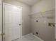 Laundry room with built-in shelving and tile flooring at 646 Lakes Cir, Lithonia, GA 30058