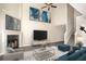 Bright, airy living room features a fireplace, a ceiling fan, and a staircase to the second floor at 646 Lakes Cir, Lithonia, GA 30058