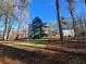 Wide angle shot of the backyard showing the house, shop, and landscaping at 135 Cedarwood Ln, Roswell, GA 30075