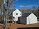 Exterior shot of the backyard showing the home, workshop, and surrounding landscape at 135 Cedarwood Ln, Roswell, GA 30075