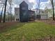 Picturesque backyard with a beautiful lawn, mature trees, and a serene setting at 135 Cedarwood Ln, Roswell, GA 30075