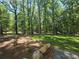 Manicured lawn and natural forest area on property at 135 Cedarwood Ln, Roswell, GA 30075