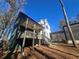 Back exterior view of the home featuring a spacious deck and stairs, perfect for enjoying the outdoors at 135 Cedarwood Ln, Roswell, GA 30075