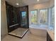 Luxurious bathroom with soaking tub, walk-in shower, and large windows at 135 Cedarwood Ln, Roswell, GA 30075