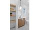Modern bathroom features a wooden vanity, frameless shower, and unique light fixture at 135 Cedarwood Ln, Roswell, GA 30075