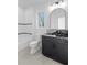 Bathroom featuring a black vanity with light tile floors and a shower/tub combo at 135 Cedarwood Ln, Roswell, GA 30075