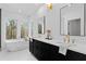 Bathroom featuring a modern tub, double sink vanity, and marble floors at 135 Cedarwood Ln, Roswell, GA 30075