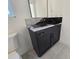 Bathroom featuring a dark vanity with a granite countertop at 135 Cedarwood Ln, Roswell, GA 30075