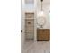 Modern bathroom featuring floating shelves, a stylish vanity, a round mirror, and contemporary lighting at 135 Cedarwood Ln, Roswell, GA 30075
