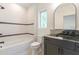Bathroom featuring bathtub with black fixtures, granite countertop, and black cabinetry at 135 Cedarwood Ln, Roswell, GA 30075