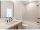 Bathroom showcasing vanity, sink, toilet, and bathtub with shower head at 135 Cedarwood Ln, Roswell, GA 30075