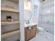 Modern bathroom featuring a walk-in shower, stylish vanity, and open shelving, combining functionality with aesthetic appeal at 135 Cedarwood Ln, Roswell, GA 30075