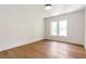 Bright bedroom features hardwood floors and natural light from the two windows at 135 Cedarwood Ln, Roswell, GA 30075