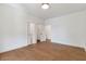 Bright bedroom with hardwood floors, fresh white paint, and closet at 135 Cedarwood Ln, Roswell, GA 30075