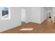A view of the bedroom with white walls, wood floors, and additional rooms at 135 Cedarwood Ln, Roswell, GA 30075