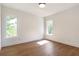 Bright bedroom features hardwood floors and natural light from the two windows at 135 Cedarwood Ln, Roswell, GA 30075