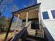 View of covered deck showing ceiling fan, gray railing and stairs leading to the yard at 135 Cedarwood Ln, Roswell, GA 30075