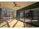 Covered porch with wood decking, ceiling fan, and wooded views at 135 Cedarwood Ln, Roswell, GA 30075