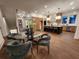 Dining area with modern lighting, sleek chairs, and glass top table next to the open-concept kitchen and stainless appliances at 135 Cedarwood Ln, Roswell, GA 30075