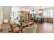 Open concept dining area featuring modern lighting, seating for eight, and hardwood flooring at 135 Cedarwood Ln, Roswell, GA 30075