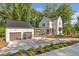 Charming two-story home featuring a detached garage and a spacious driveway at 135 Cedarwood Ln, Roswell, GA 30075