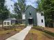 Stunning modern farmhouse with a lush landscaped front yard and walkway at 135 Cedarwood Ln, Roswell, GA 30075