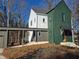 Two-story house with green and white siding, along with attached carport at 135 Cedarwood Ln, Roswell, GA 30075