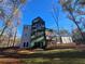 A view of a modern backyard featuring a large home and connecting detached garage at 135 Cedarwood Ln, Roswell, GA 30075