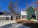 Two-story modern farmhouse with green and white exterior, attached garage, and landscaping at 135 Cedarwood Ln, Roswell, GA 30075