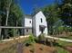 Bright home with a covered walkway and professionally landscaped front yard at 135 Cedarwood Ln, Roswell, GA 30075