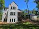 Modern two-story home with clean lines and ample windows, complemented by a spacious backyard and inviting outdoor porch at 135 Cedarwood Ln, Roswell, GA 30075